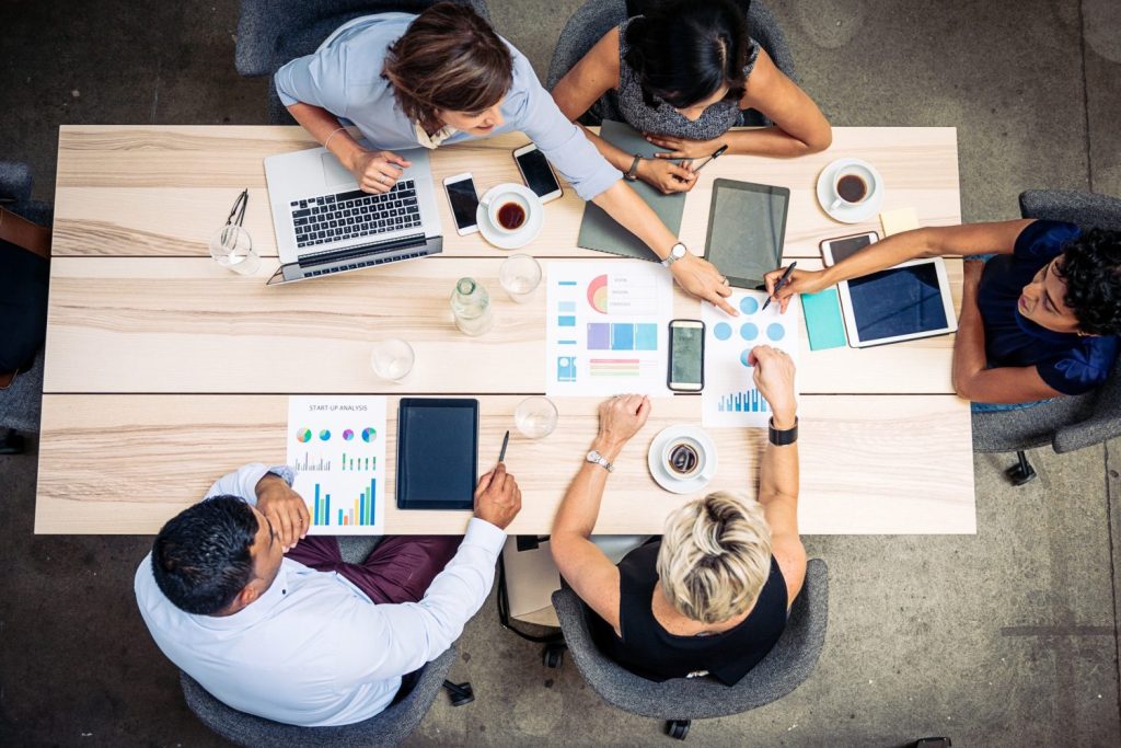 Group of business professionals sitting at a table making decisions together