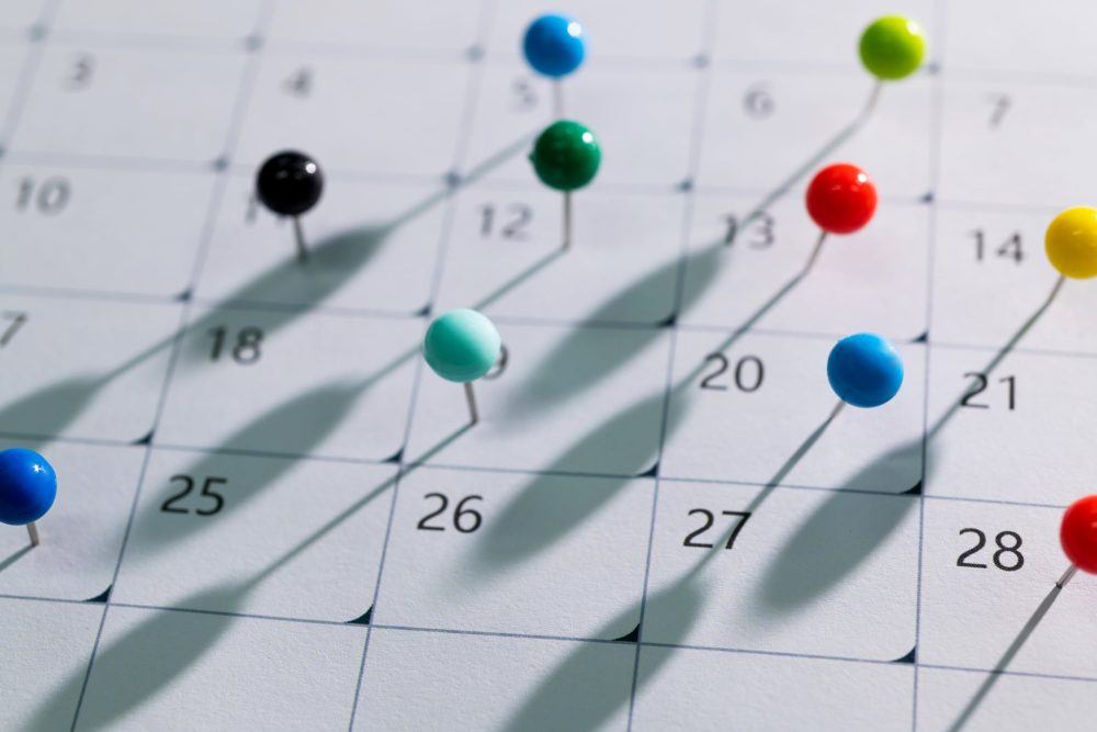 Calendar with push pins on different dates